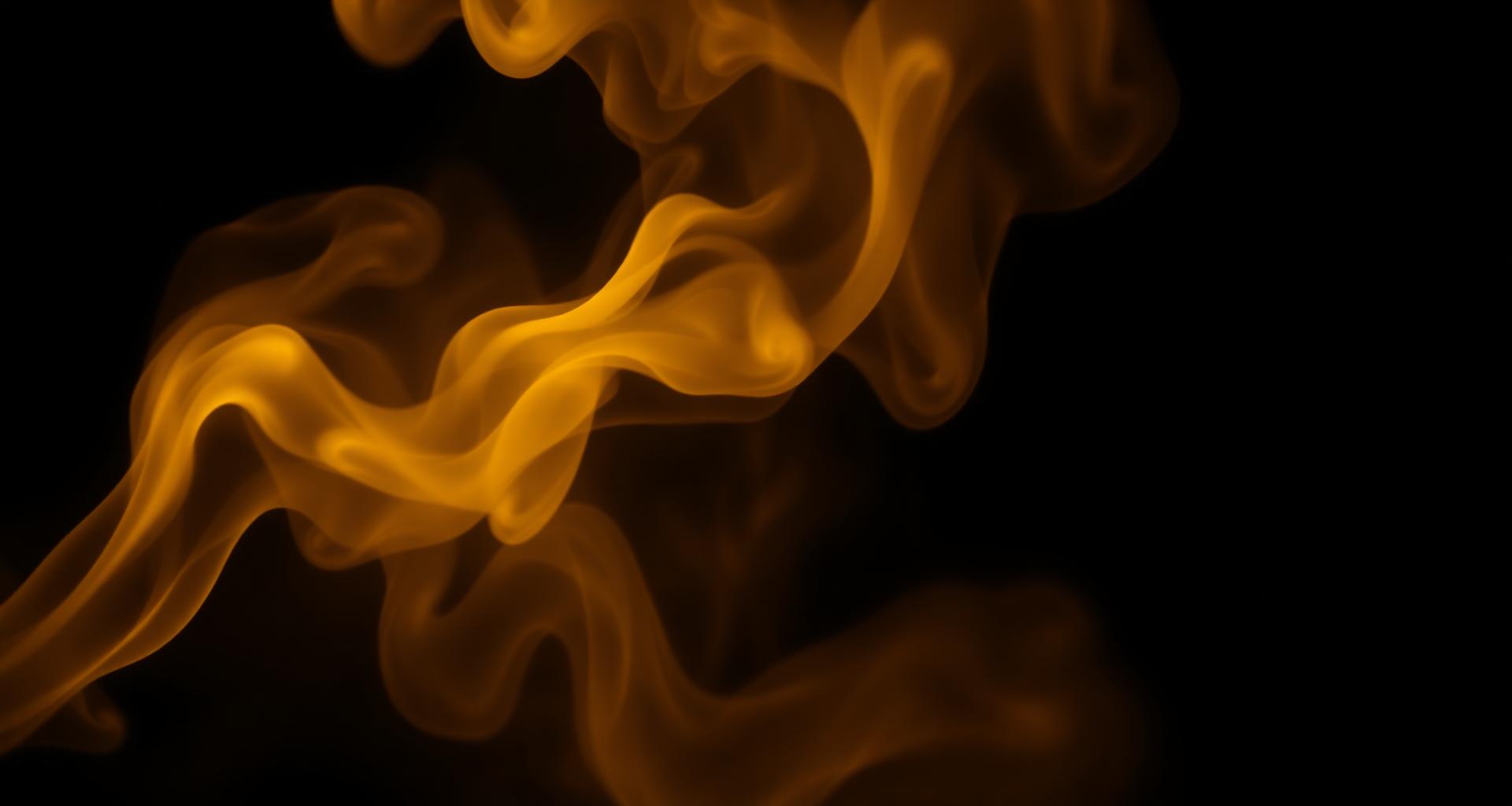 Champagne gold smoke drifting through darkness